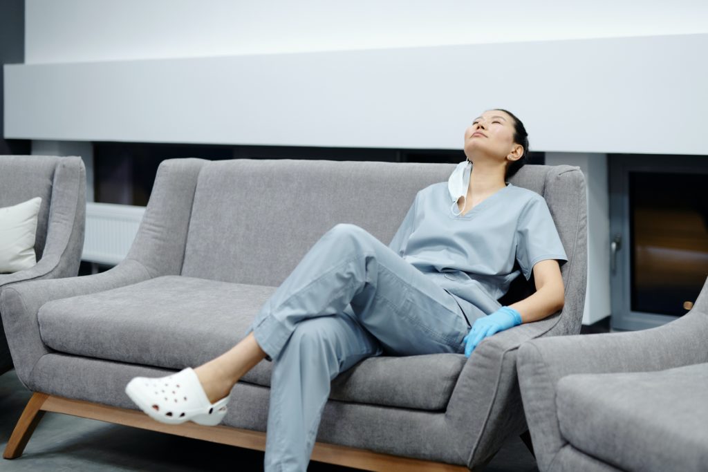 Tired Healthcare worker sitting on couch