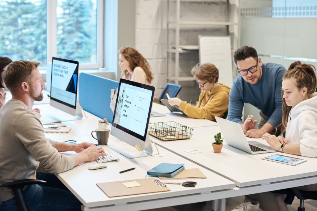 5 to 6 employees working in an office space.