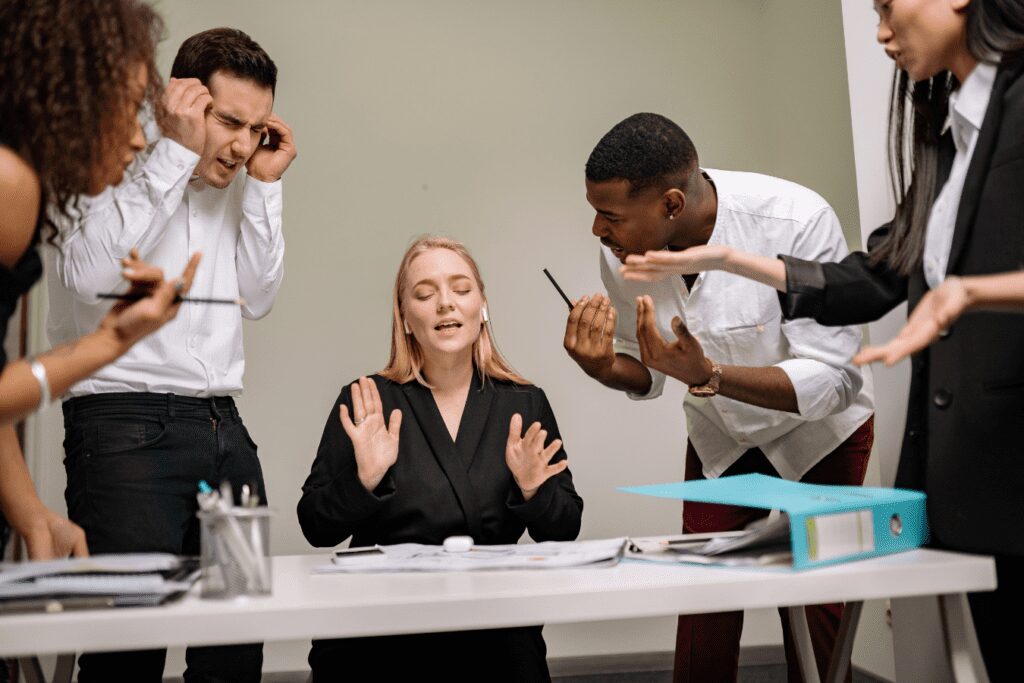 Multiple Coworkers Stressing Female Employee