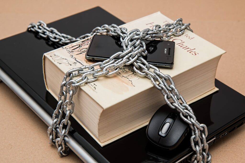 Data Privacy: Books and laptop caged  and locked.